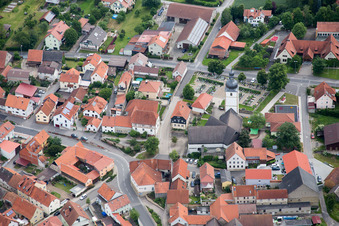 Aerial photograpy of Village - view on the edge of agricultural fields and farmland in Grossbardorf in the state Bavaria, Germany