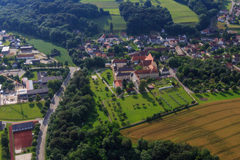 Aerial view of Parish Church of St. Mary's Assumption and St. Mary's Secondary School with monastery garden and solar park in Niederviehbach in the state Bavaria, Germany