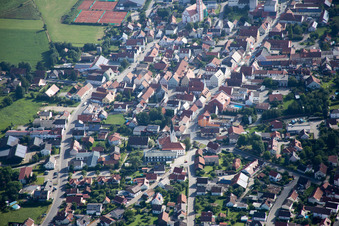 Town View of the streets and houses below clouds of the residential areas in Geiselhoering in the state Bavaria from above