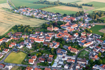 Aerial view of Village - view on the edge of agricultural fields and farmland in Lautersheim in the state Rhineland-Palatinate, Germany