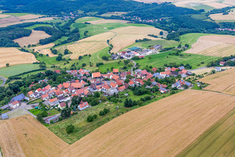 Aerial view of Village - view on the edge of agricultural fields and farmland in Seelen in the state Rhineland-Palatinate, Germany
