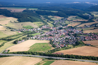 Aerial view of Village - view on the edge of agricultural fields and farmland in Muenchweiler an der Alsenz in the state Rhineland-Palatinate, Germany