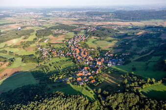 Village - view on the edge of agricultural fields and farmland in Schlaifhausen in the state Bavaria, Germany