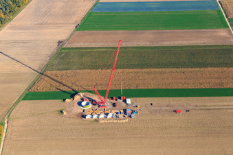 Oblique view of Construction site at the wind turbine foundation with crane in the wind farm Hatzenbühl in Hatzenbühl in the state Rhineland-Palatinate, Germany