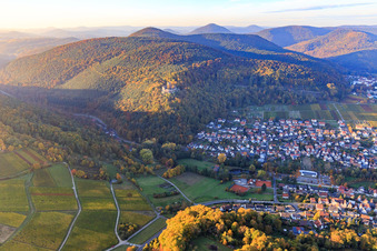 View of the village below the castle ruins of Landeck Castle in the autumn forest at evening light in Klingenmünster in the state Rhineland-Palatinate, Germany