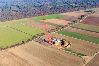 Aerial view of Construction site wind turbine foundation with crane in Hatzenbühl in the state Rhineland-Palatinate, Germany