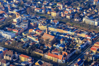Town houses on the town square and parish church of St. Simon and Judas from the southeast in Pfarrkirchen in the state Bavaria, Germany