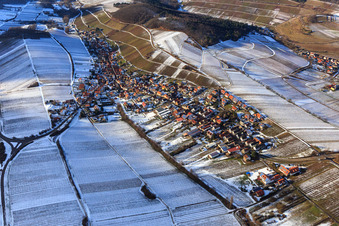 Aerial view of View of the winegrowing village in winter with snow-covered vineyards from the east in Ranschbach in the state Rhineland-Palatinate, Germany