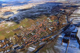View of the winegrowing village in winter between snow-covered vineyards from the west in Siebeldingen in the state Rhineland-Palatinate, Germany