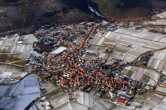 Aerial view of View of a winegrowing village on the edge of the Haardt in winter between snow-covered vineyards from the south in Frankweiler in the state Rhineland-Palatinate, Germany