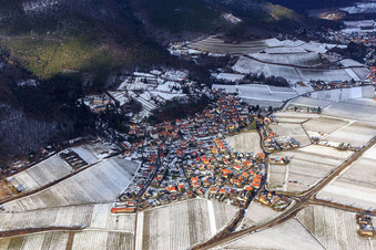 View of a winegrowing village on the edge of the Haardt in winter between snow-covered vineyards from the south in Gleisweiler in the state Rhineland-Palatinate, Germany