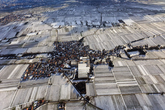 Aerial view of View of a winegrowing village in winter between snow-covered vineyards from the north in Böchingen in the state Rhineland-Palatinate, Germany