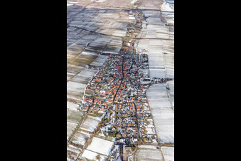 Wintry snowy Village - view on the edge of agricultural fields and farmland in Roschbach in the state Rhineland-Palatinate, Germany