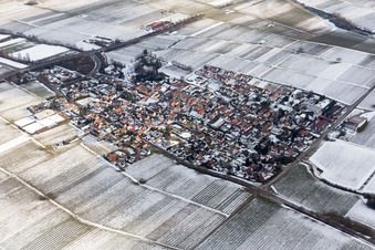 Wintry snowy Village - view on the edge of agricultural fields and farmland in Walsheim in the state Rhineland-Palatinate, Germany