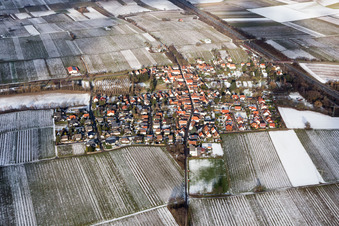 Wintry snowy Village - view on the edge of agricultural fields and farmland in Knoeringen in the state Rhineland-Palatinate, Germany