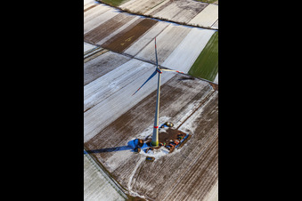 Oblique view of The first wind turbine of the Hatzenbühler wind farm in winter with snow in Hatzenbühl in the state Rhineland-Palatinate, Germany