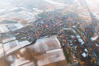 Wintry snowy Village - view on the edge of agricultural fields and farmland in Riedseltz in Grand Est, France