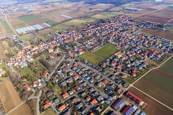 Village overview from the southwest with sports field of SV Gommersheim 1945 eV in the village center in Gommersheim in the state Rhineland-Palatinate, Germany