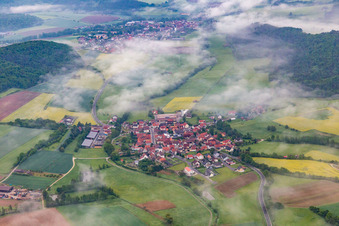 Aerial view of Village under clouds in the district Wustviel in Rauhenebrach in the state Bavaria, Germany