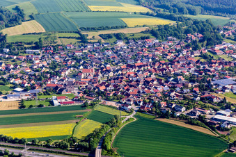 Aerial view of Village - view on the edge of agricultural fields and farmland in Stettfeld in the state Bavaria, Germany