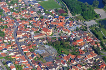 Village center with St. Nicholas Church Sand am Main and greenhouses of Blumen Zösch in Sand am Main in the state Bavaria, Germany