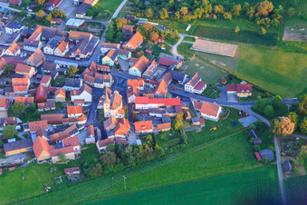Aerial view of Village edge with St. Vitus Church from the north in the district Kaisten in Wasserlosen in the state Bavaria, Germany