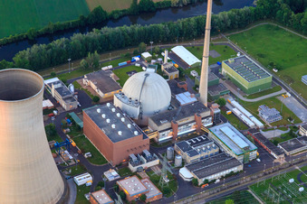 Cooling towers and reactor dome of the nuclear power plant Grafenrheinfeld of Preussenelektra GmbH at sunset in Grafenrheinfeld in the state Bavaria, Germany