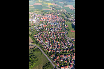 Aerial photograpy of Village - view on the edge of agricultural fields and farmland in Stadtlauringen in the state Bavaria, Germany