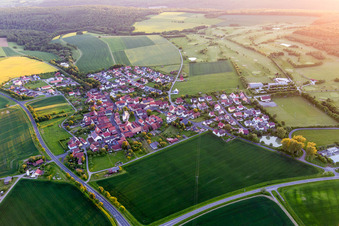 Village - view on the edge of agricultural fields and farmland in the district Loeffelsterz in Schonungen in the state Bavaria, Germany