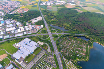 Motorway cloverleaf of the Schweinfurt-Zentrum junction from the A70 to the B285 with parking and allotment gardens at the lake in Schweinfurt in the state Bavaria, Germany