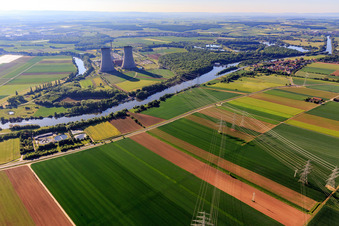 Cooling towers and high-voltage lines to the nuclear power plant Grafenrheinfeld of Preussenelektra GmbH on the Main river bank from the west in Grafenrheinfeld in the state Bavaria, Germany