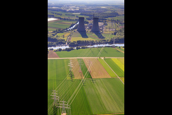 Oblique view of Cooling towers and high-voltage lines to the nuclear power plant Grafenrheinfeld of Preussenelektra GmbH on the Main river bank from the west in Grafenrheinfeld in the state Bavaria, Germany