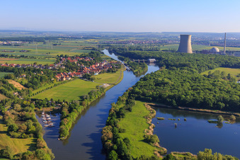 Harbor in front of and cooling tower of the Grafenrheinfeld nuclear power plant behind the village on the banks of the Main from the south in the district Garstadt in Bergrheinfeld in the state Bavaria, Germany