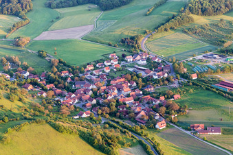 Village - view on the edge of agricultural fields and farmland in Eschenau in the state Bavaria, Germany