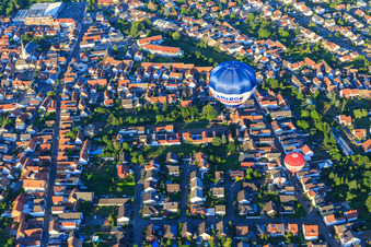 Two hot air balloons over Eichgartenstr in Dudenhofen in the state Rhineland-Palatinate, Germany