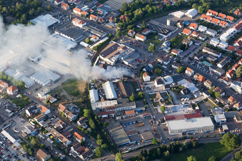 Aerial view of Smoke and flames during the fire fighting to fire of a storage all for antiqities in the Werkstrasse in Speyer in the state Rhineland-Palatinate, Germany