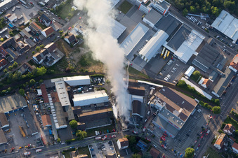 Smoke and flames during the fire fighting to fire of a storage all for antiqities in the Werkstrasse in Speyer in the state Rhineland-Palatinate, Germany out of the air