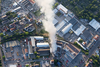 Smoke and flames during the fire fighting to fire of a storage all for antiqities in the Werkstrasse in Speyer in the state Rhineland-Palatinate, Germany seen from above