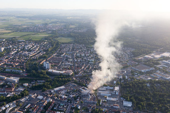 Smoke and flames during the fire fighting to fire of a storage all for antiqities in the Werkstrasse in Speyer in the state Rhineland-Palatinate, Germany viewn from the air