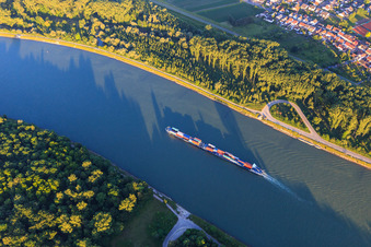 Cargo ship on the Rhine in the evening in the district Rheinhausen in Oberhausen-Rheinhausen in the state Baden-Wuerttemberg, Germany