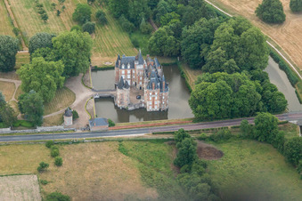 Building and castle park systems of water castle Chateau de Combreux in Combreux in Centre-Val de Loire, France seen from above