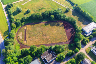 Overgrown sports field and cinder track in the former barracks area (Alfred Delp Quarter) on Sternschanzenstraße in Donauwörth in the state Bavaria, Germany