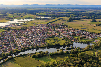 View of the town from the east behind the waters Fish meal on the Rhine dam in Leimersheim in the state Rhineland-Palatinate, Germany