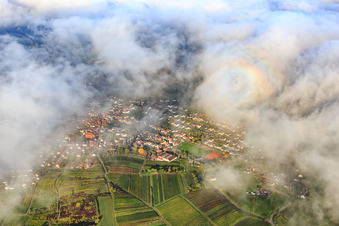 View of the town under clouds from the east with the Catholic parish church of St. Stephan in Albersweiler in the state Rhineland-Palatinate, Germany