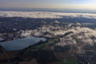 Gravel pit for gravel extraction by Pfadt GmbH Kieswerk-Baustoffe under clouds in Leimersheim in the state Rhineland-Palatinate, Germany