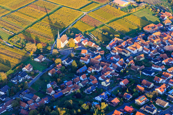 Wine-growing village from the west with protest. Church among autumn-colored vineyards in the district Rechtenbach in Schweigen-Rechtenbach in the state Rhineland-Palatinate, Germany