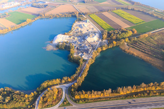 Quarry lake in the Rhine meadows on the B9 with gravel works of Holcim Kies und Beton GmbH in Rheinzabern in the state Rhineland-Palatinate, Germany