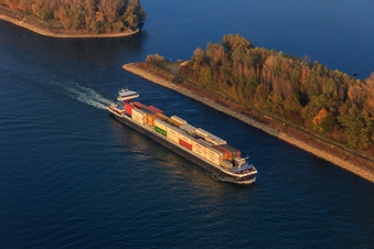 Container ship on the Rhine near Rußheimer Altrhein in Germersheim in the state Rhineland-Palatinate, Germany