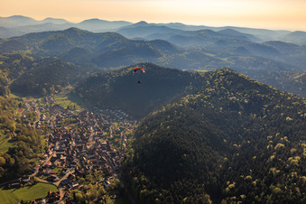 Paraglider over the village in Vorderweidenthal in the state Rhineland-Palatinate, Germany