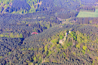 Drachenfels castle ruins with red paraglider in Busenberg in the state Rhineland-Palatinate, Germany